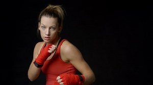 Blonde female boxer shadow boxing to camera, close-up