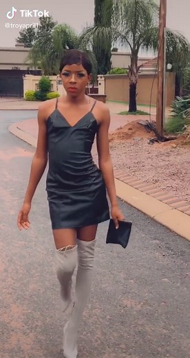 Stylish Outdoor Walk: Black Dress and Knee-High Boots