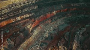 Panorama aerial view shot open pit mine coal mining, dumpers, quarrying extractive industry stripping work. Big Yellow Mining Trucks. View from drone at opencast mining with lots of machinery trucks