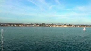 Sailing yacht on the Pacific ocean, as seen from Santa Cruz Beach Boardwalk in Santa Cruz County, California, USA