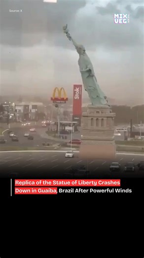 mixveg on Instagram: "A dramatic incident was reported from Guaíba, Brazil, where a replica of the Statue of Liberty came crashing down after being battered by powerful winds. The structure, which stood as a prominent local attraction, collapsed during the severe weather, startling residents and passersby as its upper portion gave way under the force of the gusts. Visuals from the scene show the fallen monument lying across the area where it once stood upright, raising concerns about structural