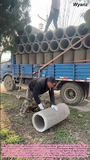 two workers unloading large stone columns from truck | daily construction routine
