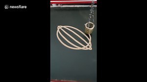 Mesmerising pendulum creates beautiful pattern with sand
