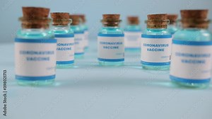 Syringe needle, a drop liquid, blurred pfizer company on the blue background. Coronavirus vaccine concept. Covid-19 inoculation jointly developed. Ready-made preparations with doses