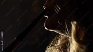 Hookah smoker. Young woman smoking shisha or hookah in cafe or bar. Resting in shishabar lounge.