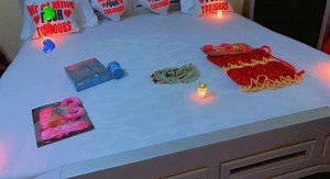 Cozy Bed Decor with Heart-Shaped Pillows and Candles