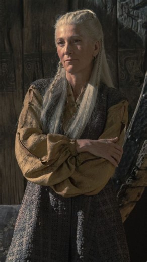 Luv on Instagram: "“She was never crowned… yet she was never forgotten.” Rhaenys Targaryen, The Queen Who Never Was, standing with quiet authority and restrained fire, silver-white Valyrian hair flowing in the wind, sharp intelligent eyes filled with wisdom, pride, and unspoken grief. She wears an elegant black-and-red Targaryen gown embroidered with dragon sigils, Valyrian steel jewelry, and a crown subtle yet regal, symbolizing a throne denied. Her posture is calm but commanding, a woman who k