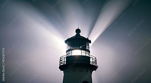 A rotating light beams from the top of a solitary lighthouse on a foggy night.
