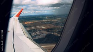 Earth through an airplane window trees land earth lakes and fields aerial view