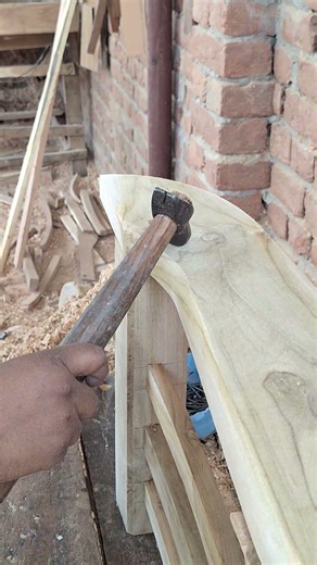 The correct way to hammer a nail into wood.