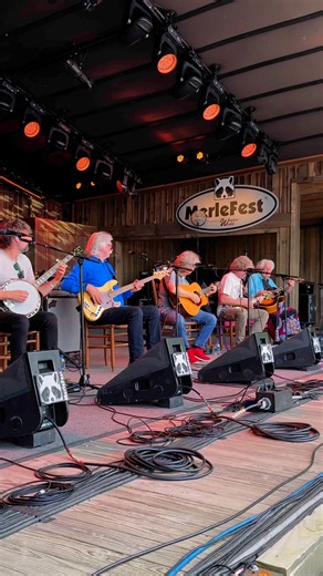 Happening now on the Watson Stage: the MerleFest Veterans Jam with Jack Lawrence, Joe Smothers, Sam Bush, Peter Rowan, T. Michael Coleman, and Wes Corbett! #merlefest #merlefest2025 #musicmomentsmemories | MerleFest
