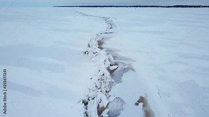 AERIAL: 4K drone aerial of frozen Lake Winnipeg in Manitoba, Canada and a large pressure ridge running along the south basin. Ice ridge is near Hecla, Gull Island, and Riverton.