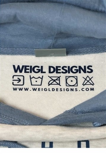 Most people never see this part, but every Weigl Designs shirt gets branded on the inside too.💙 Pressed by me, one by one, because details matter. This year one of my goals is to be more consistent with the little things that make my brand feel intentional. Michigan made, woman-owned, cozy as hell.🫶