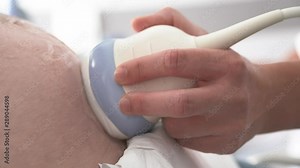 Ultrasound machine electrotherapy device scanner on a pregnant belly, closeup