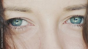 Blue eyes closeup, eyesight of young woman looking away, health care and vision concept. High quality FullHD footage