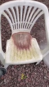 Powerwashing a dirty plastic chair