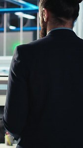 Vertical Photovoltaics factory engineer using software on laptop to improve solar panels efficiency. Solar panels manufacturing plant employee researching sustainable solar solutions using notebook, camera A