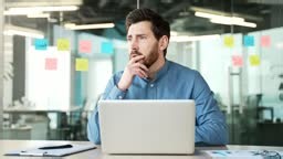 Shocked stressed businessman reads bad news on laptop while sitting...