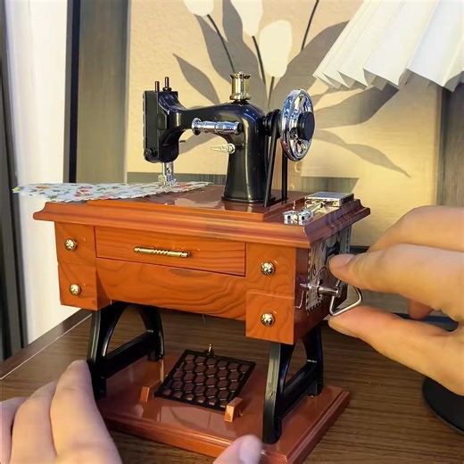"Bring back the sweet nostalgia of grandma’s sewing room 🧵🎶 Our Vintage Sewing Machine Music Box is more than decor – it’s a piece of timeless charm. Wind it up, and watch the tiny needle “stitch” as a soft, classic melody plays. Perfect for your desk, shelf, or vanity – it adds a cozy, retro touch to any space. Crafted with intricate details, it’s a beautiful keepsake that brings joy every time you wind it up. Grab your nostalgic music box today – let the melodies of the past warm your presen