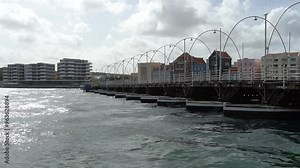 Queen Emma bridge is swinging, pontoon bridge across St. Anna Bay connecting Punda to Otrobanda berth of Willemstad, capital of Curacao in the Caribbean.