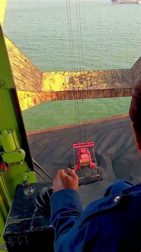 POV loading coal into ship with crane real work