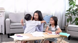 Asian female teacher teaching assignments for primary school children at home or private tutoring, boy and girl siblings doing homework together, family relationship mother spend weekend with kids Stock Video