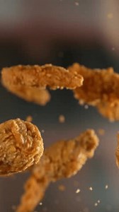 Super slow motion of flying tasty chicken pieces with camera movement. Filmed on high speed cinema camera, 1000 fps.