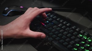 Pressing buttons on a backlit keyboard close-up