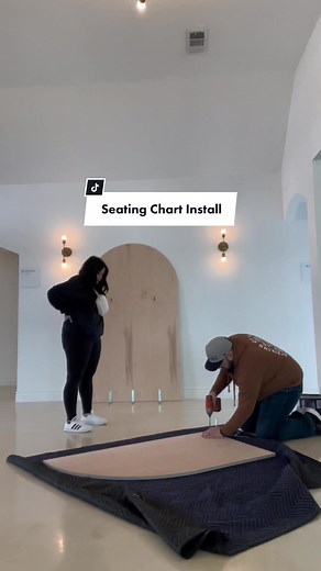 Supervising Seating Chart Installation at Wedding - Olivia Meabe