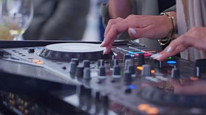 Dj artist scratching vinyl during beach event