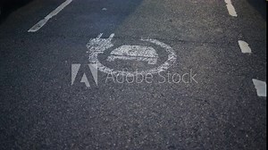A chalk drawing of an EV charging station on a roadside asphalt surface