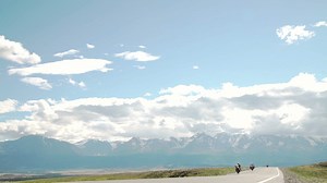 Motorcycle choppers ride down mountain road - Free Stock Video