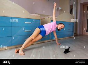 Tennage girl doing fitness gymnastics at home. Gymnastics video tutorial. Gymnastic exercises. Children's activity in quarantine during coronavirus pa Stock Photo - Alamy