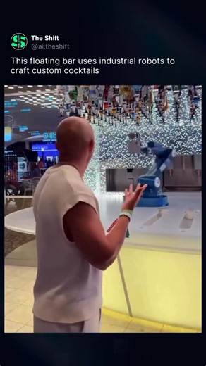 The Shift on Instagram: "This bar feels like it’s pulled straight from the future, with two fully automated robotic arms replacing human bartenders and mixing cocktails with precise movements, measured pours, and smooth robotic choreography. Passengers order digitally, the system pulls the exact bottles from a massive overhead liquor wall, and the robots shake, stir, and pour each drink onto a conveyor-style counter for pickup. It’s all happening onboard Royal Caribbean’s Wonder of the Seas, tur