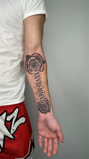  Tattoo with roses and Roman numerals This design combines two...