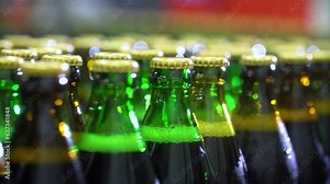 Conveyor with glass bottles at the plant for the production of various beers, soda, water or other alcoholic or soft drinks