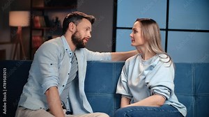 Happy middle-aged spouses talking about relationships, sitting on soft sofa in living room at home Stock Video