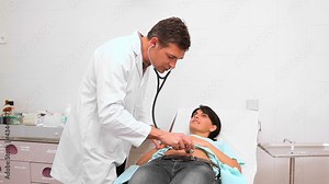 Doctor auscultating patient belly with a stethoscope Stock Video