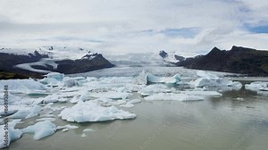 Majestic Icelandic glaciers with floating icebergs on a serene, cloudy day