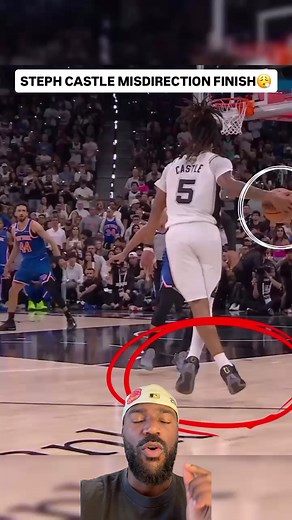 This is a great use of footwork, and no, it was not a travel. Steph Castle has the ball just in front of the 3-point line on the right wing and starts by attacking the defender while standing upright with the ball and hanging it outside his body while floating forward. He then drops low to the ground, takes a hard pound dribble with his right hand, and takes a wide step with his left as if he were going in that direction. As soon as his left foot plants, he gathers the ball, making that his zero
