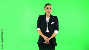 Indignant woman throwing up hands expressing she is innocent, twists his finger at his temple. Green screen