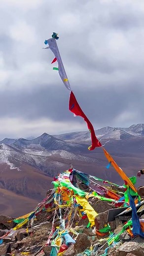 Tibetan Flags Unfurled Against Majestic Mountains