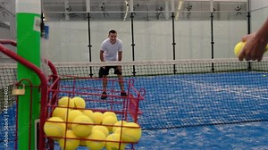 Paddle tennis training with racket and balls, training with basket plenty of balls