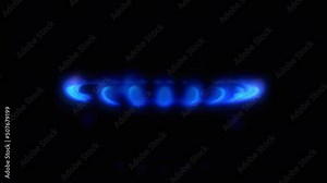 Gas stove kitchen burner flaming in the dark, close up. Methane firing up with blue flame on gas stove switching on in total dark room. Side view, 4k