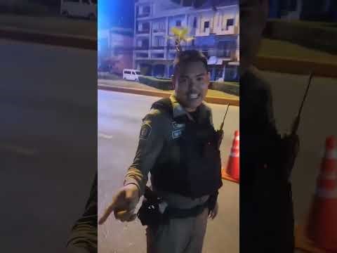 #Rayong Officials set up a checkpoint for alcohol breath tests. A young man from Rayong protested...