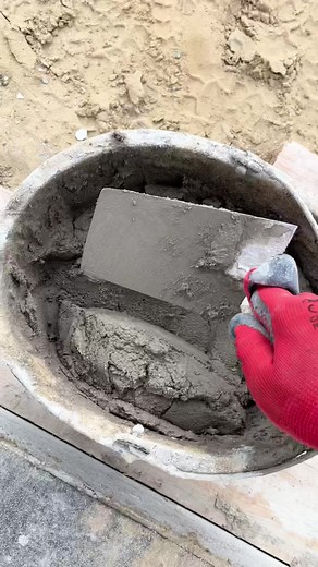 Applying Fresh Cement with Trowel at Construction Site