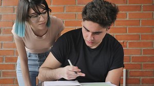 Student confused with homework is helped by her classmate - Free Stock Video