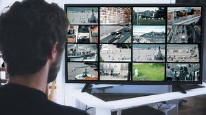 Watching City Multi Cams On Split Screen Monitor. Man Watch CCTV cameras surveillance system monitoring people in many places. Multiscreen monitor.