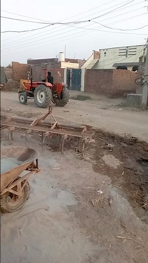 Tractor Driving Through a Peaceful Village