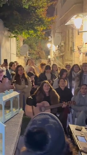 ‎𝐑𝐢𝐤𝐚 𝐑𝐚𝐳𝐞𝐥 ריקה רזאל‎ on Instagram: "What a special scene here in Nachlaot, right outside my house. The light, the people who come just to sing, to connect, to be together. Last year, the parents of Eitan Mor, who was held hostage, came and we all cried. He lived right across from my home. This year, he is home. So deeply grateful for that. And yet, yesterday in Australia, another horrific act. Again, violence by people who seem to be fighting without knowing for what. Fighting against